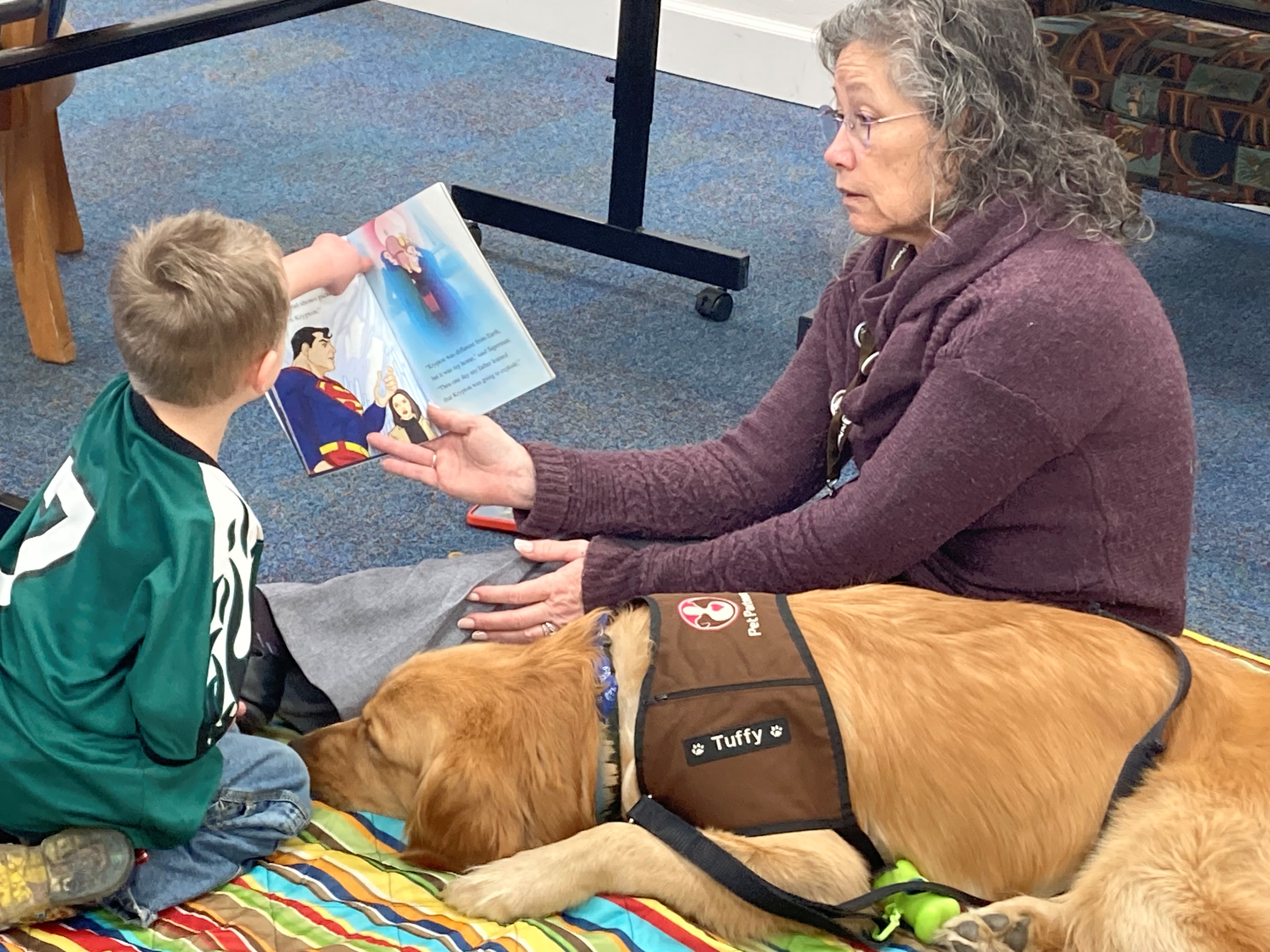 Audrey & Tuffy Reading with a young patron