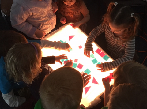 Children working around a light box