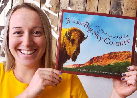 Annika holding a children's book