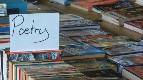 books on a table with a sign that says poetry