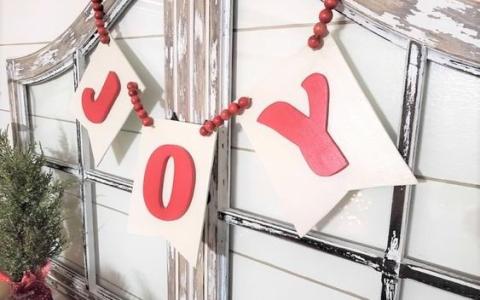 the word joy on wooden banner