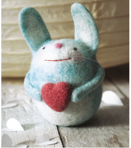 blue and white needle felted rabbit holding heart